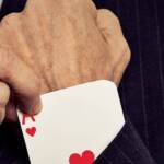 enhance customer experience - a man pulling an ace of hearts out of his sleeve