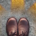 feet in brown leather shoes - steps to have a successful business